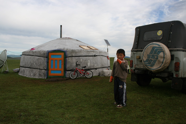 Boy in front of his grandparent's yurt, Darhadyn Hotgor